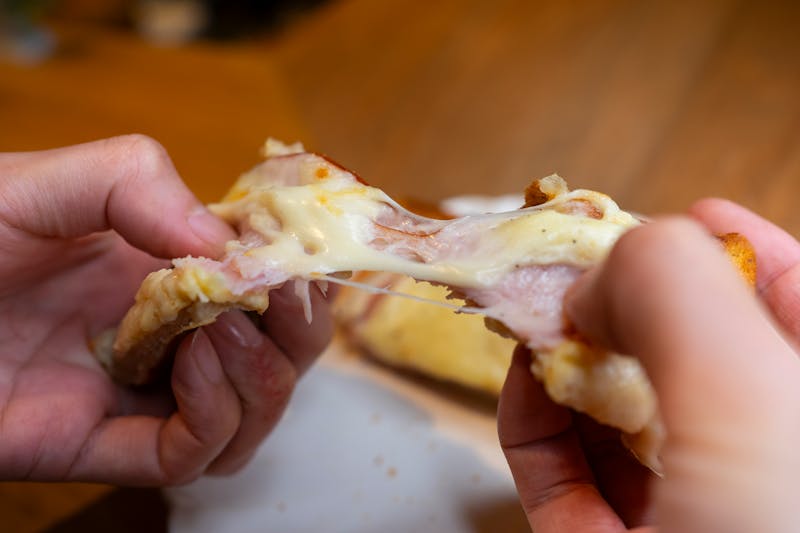 Rich tomato sauce spread on a fresh pizza base ready for toppings